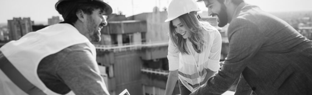 two men and a woman in hard hats