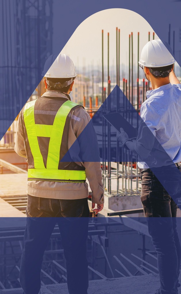 two workers overlooking construction site