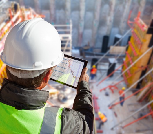construction worker looking at a tablet
